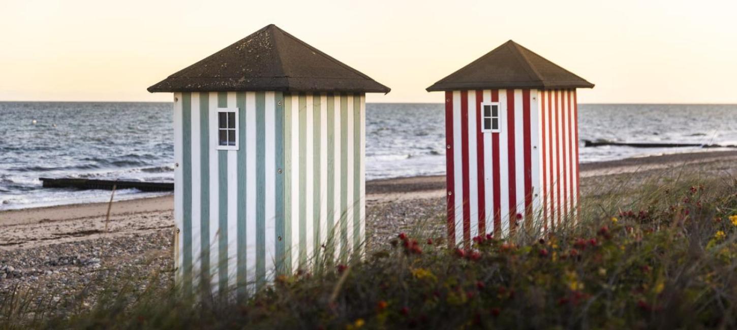 Iconic striped bathing houses on the beach in Rågeleje